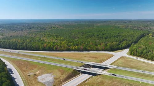 Aerial View of Freeway Overpass Junction with Fast Moving Traffic Cars and Trucks in American Rural