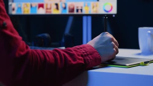 Graphic Designer Editing Photos at Desk at Night