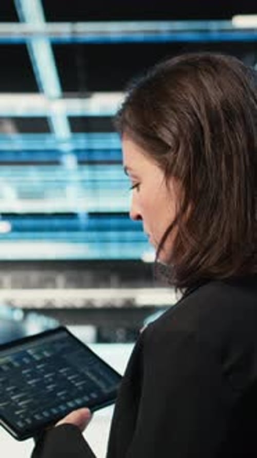 Vertical Video Data Center Programmer Coding on Tablet Optimizing Equipment Rigs