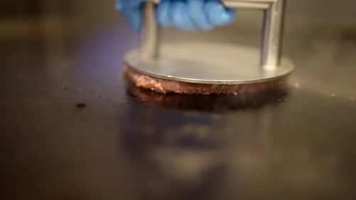 Professional Cook Roasting Beef Cutlet in Restaurant Kitchen Closeup View