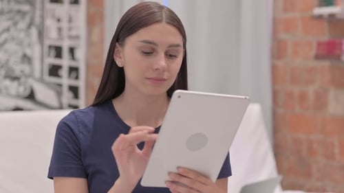 Young Adult Using Tablet Indoors