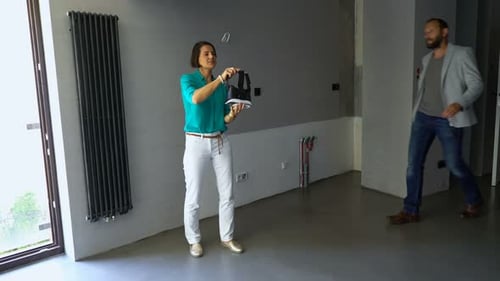Couple Uses VR Headset in Modern Empty Apartment