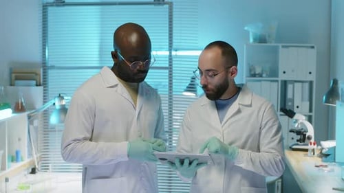 Scientists Use Tablet in Bright Modern Laboratory