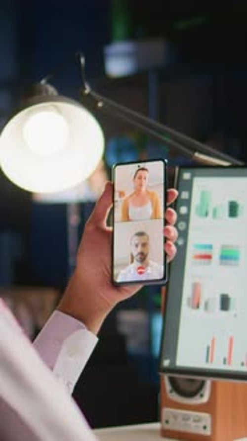 Video Call on Phone in Office at Night