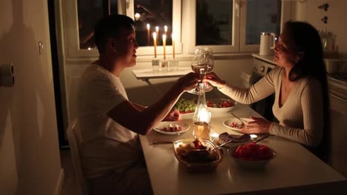 Couple Enjoying Candlelit Dinner in Cozy Kitchen