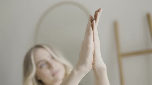 Closeup of Attractive Woman Scrubbing Skin Action Bright Atmosphere with Spa Treatments and