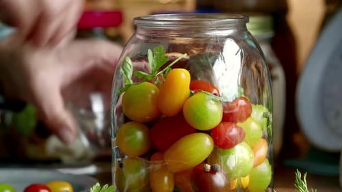 Close-Up of Filling a Jar with Colorful Cherry Tomatoes for Pickling