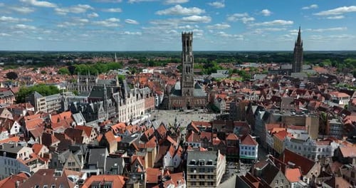 Belfry of Bruges, Belgium, June 2024. Drone orbits showing Bruges skyline from above, with its beaut