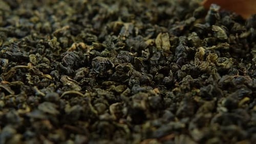 Black Dry Tea Wallpaper Wooden Spoon Picks Up Mix Black and Green Tea Leaves Close Up Macro Top View