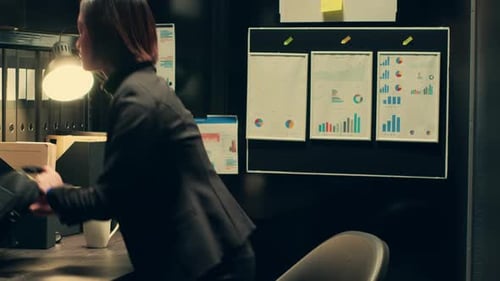 Woman Working Late on Laptop in Dark Office