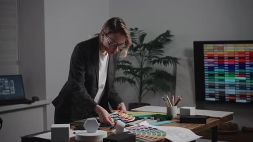 A Woman Interior Designer is Creating a Mood Board The Specialist is Using Palettes As Well As