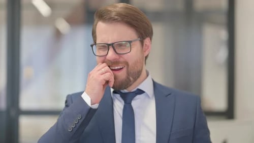 Portrait of Middle Aged Businessman with Tooth Pain