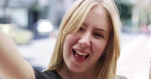 Woman Smiles and Waves in City Close Up