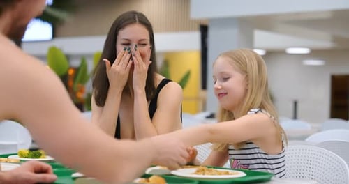 Woman and Child Enjoying Lunch Together Indoors