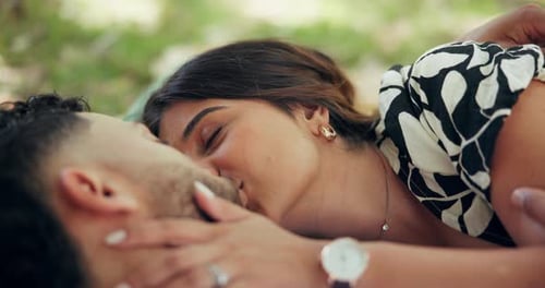 Love, couple and kiss outdoor on picnic, connection and relax together on date for chat