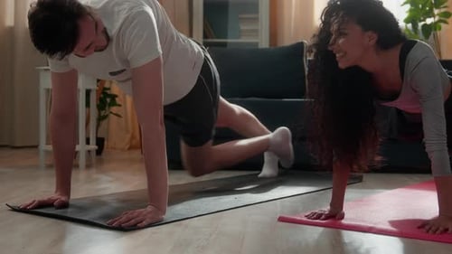 Fit Couple Exercising Together at Home