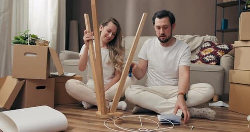 Happy Father with Mother Wife and Husband Decorating Property Space with Furniture Trying to