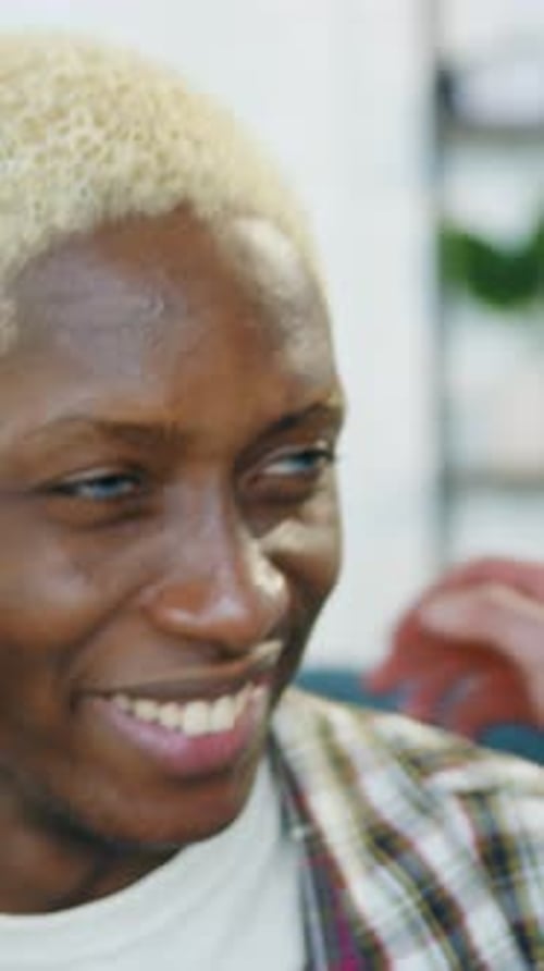 Two Young Men Embrace Affectionately Indoors