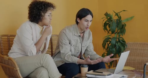 Young People Entrepreneurs Discussing Business Startup and Using Laptop Working in Creative Office