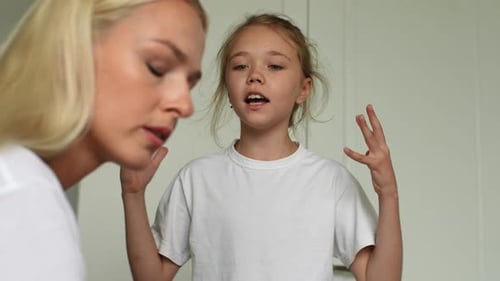 Closeup Face of Angry Cute Little Child Daughter Scolding Raising Voice Shouting and Gesturing with