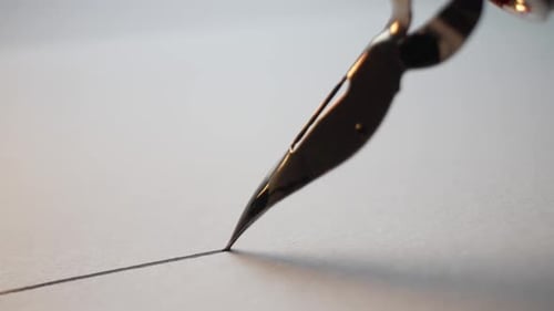 Macro of Fountain Pen Nib Writing Straight Ink Line On Textured Paper Surface