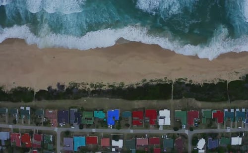 4k drone footage of a coastline alongside a city