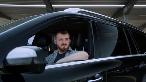 Man Sits in Black SUV Driver's Seat