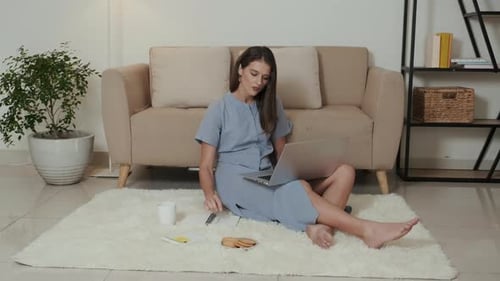 Woman Working on Laptop at Home on Rug