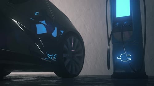 Close-Up of Electric Vehicle Plugged Into Charging Station in Dark Garage