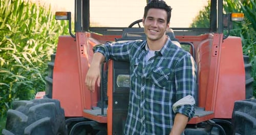 Portrait of a beautiful young farmer (student) working in the field with a tractor, successful smi