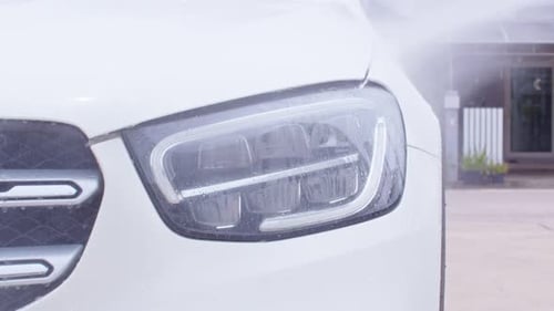 Close up water high pressure for cleaning and washing car.Water mist spraying to the white car for c