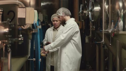 Brewery Staff Checking Batch of Freshly Brewed Beer