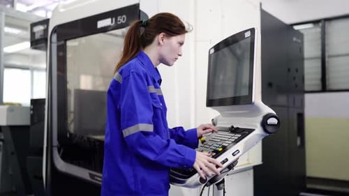 Woman Works with Machine at Computer in Factory