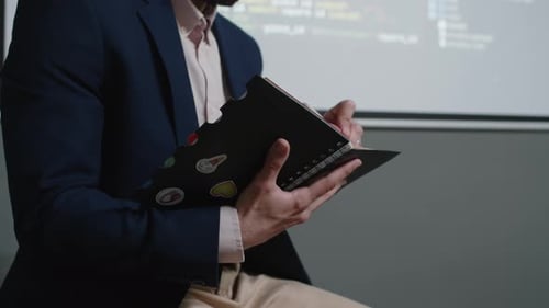 Smiling Middle Eastern Male Teacher Checking Attendance at Coding Class