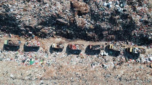 Large Waste Dump and Trash Truck with Garbage in Aerial Top View