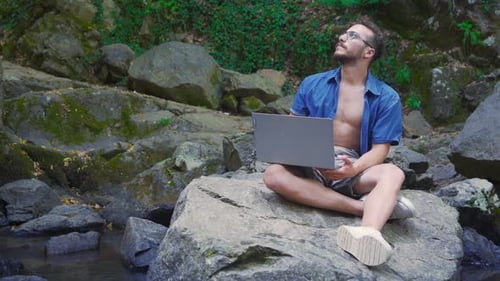 Man Working on Laptop in Natural Environment