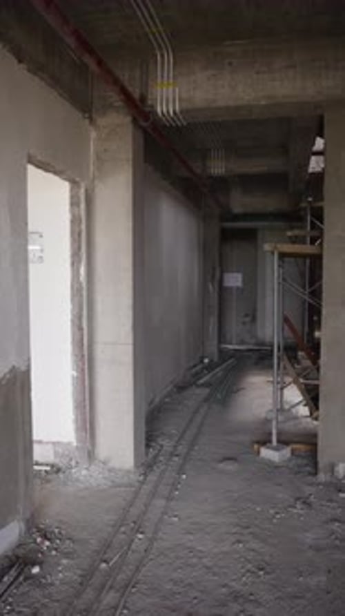 Interior of an Unfinished Construction Site with Exposed Piping and Scaffolding