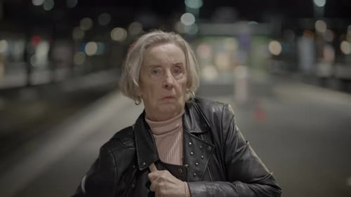 Older Woman Wearing a Leather Jacket at Night