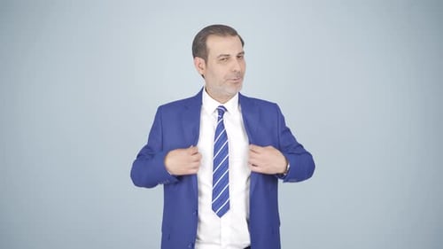 Man Talking and Gesturing in a Blue Suit