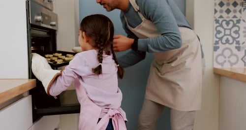 Girl and Father Baking Cookies Together at Home