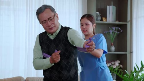 Senior Man Exercising with Assistance from Young Woman