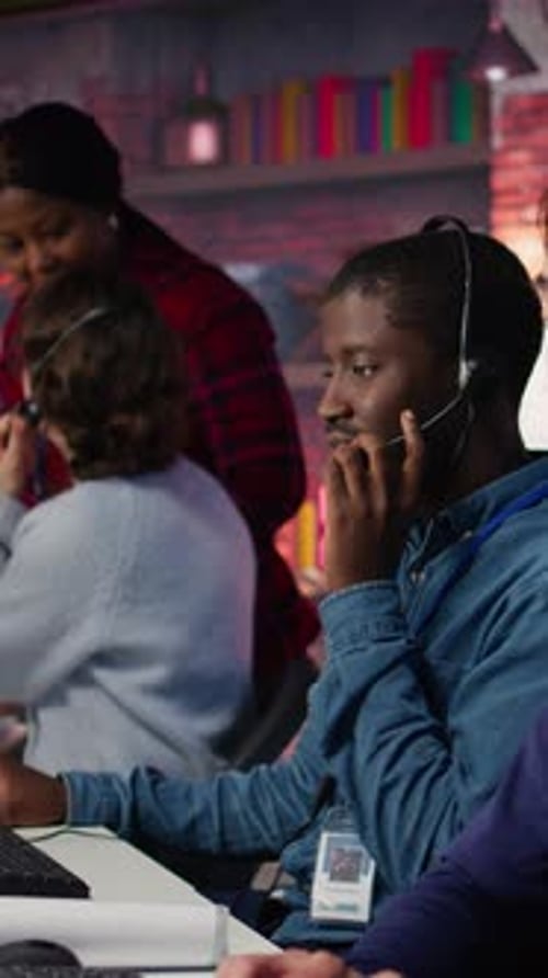 Vertical Video Call Center Operator Next to Coworkers Dealing with Upset Customers