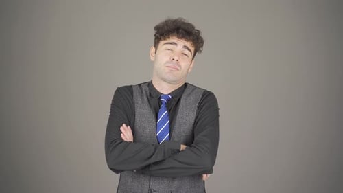 Young Man with Arms Crossed, Gray Background