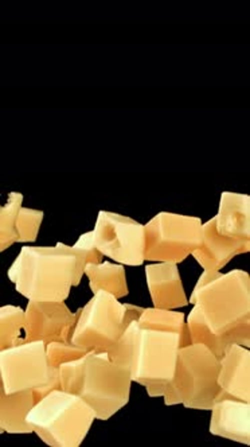 Maasdam Cheese Flies Up and Falls Down on a Black Background Filmed on a Highspeed Camera at 1000