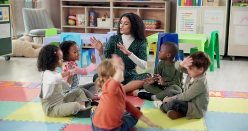 Teacher and Children Play Clapping Game in Classroom