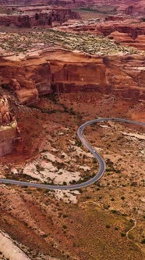 Huge rocks of canyons in Utah, USA. Motorway going round the terrific mountains through the desert.