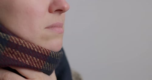 Adult Woman Applying Throat Spray for Sore Throat