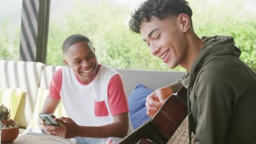 Friends Relaxing with Guitar and Smartphone