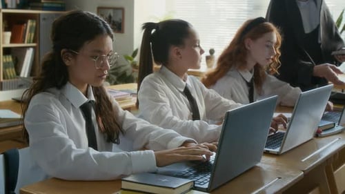 Diverse Girls Working on Laptops Studying Computer Science in Religious School