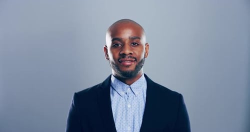 Man in Suit Jacket Making Heart Shape
